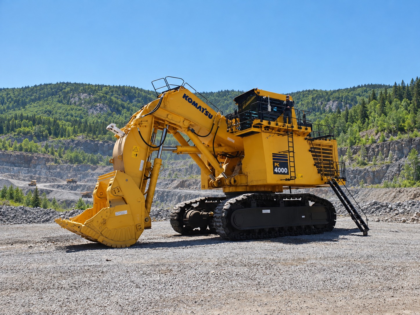 Yellow Komatsu PC4000 hydraulic mining shovel on crawler tracks with bucket grounded.